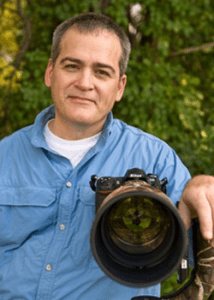 Image of Brian J Zwit with camera and big glass